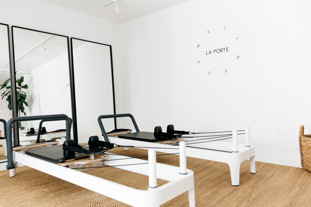 white pilates reformers in pilates yoga studio