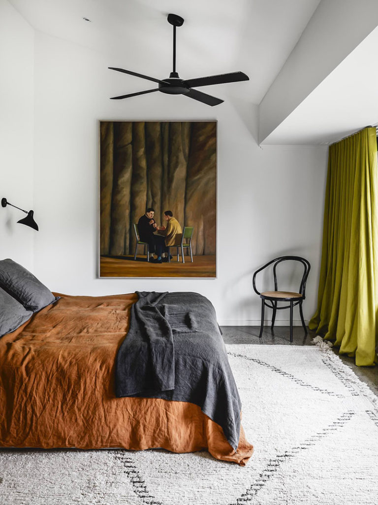 Bedroom with pumpkin inspired orange linen bedspread. Decorate with the color orange and pumpkin.