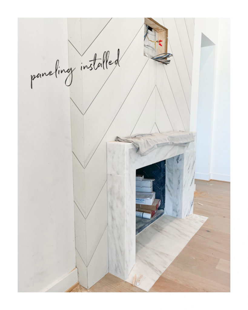 marble fireplace with chevron paneling by Nuela Designs