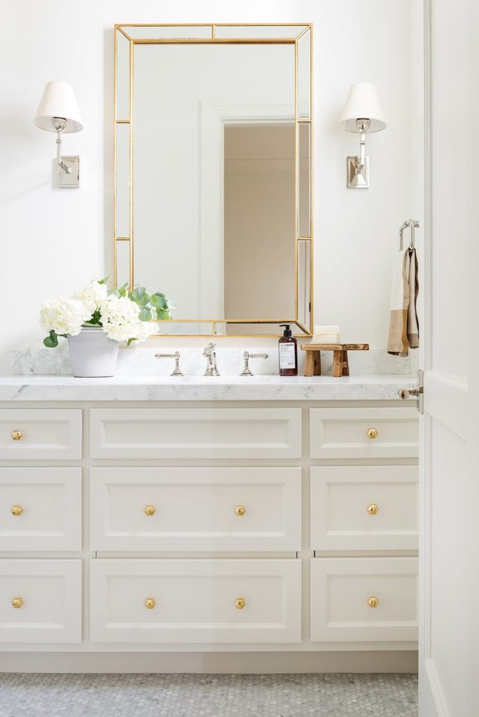 bathroom design with neutral cabinets and marble countertop
