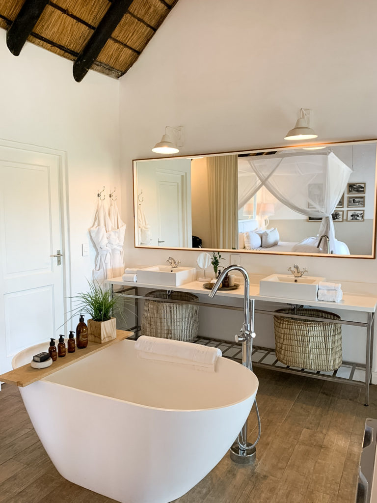 White freestanding tub and open vanity in South African safari lodge.