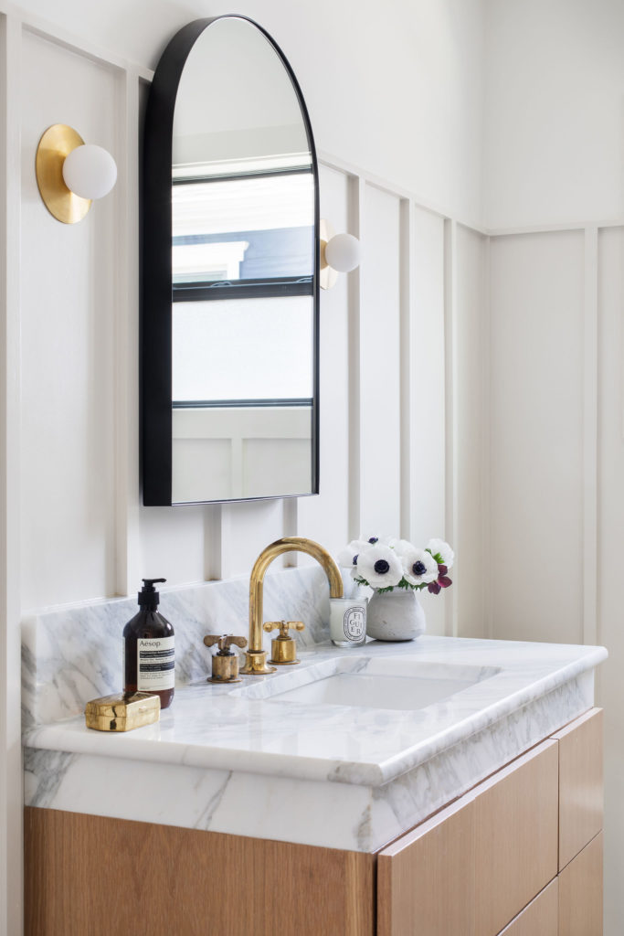 Modern Paneling Details and marble countertops in a classic transitional bathroom remodel