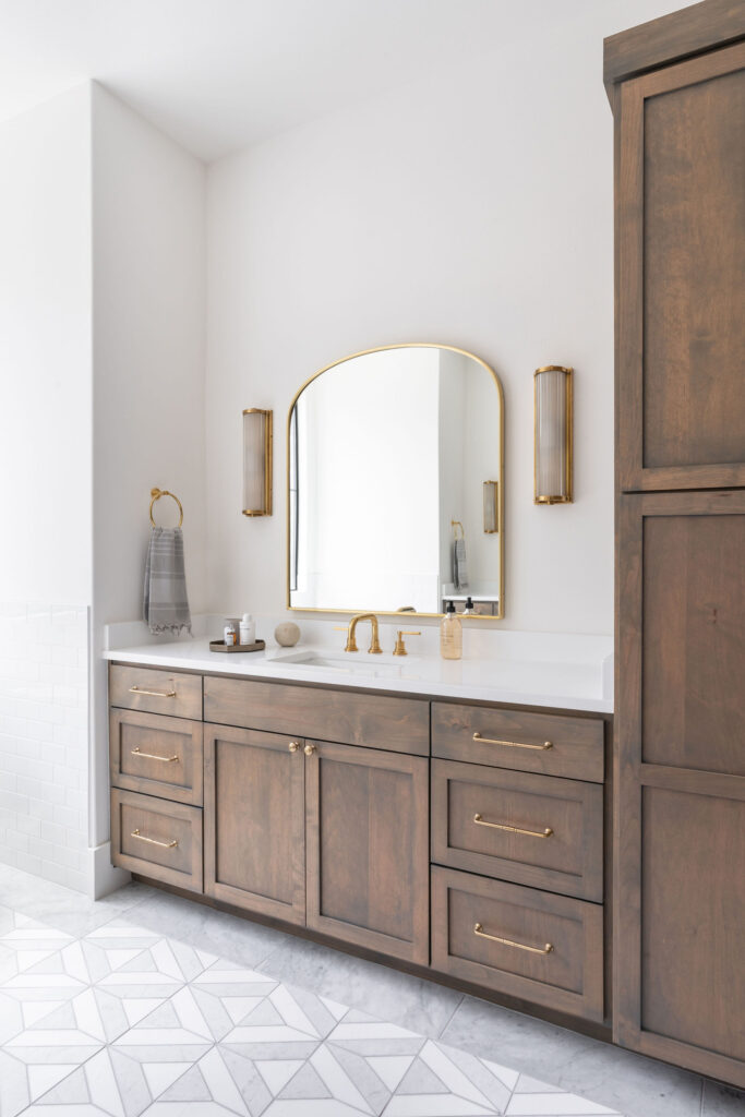 Interior Design: Warm Mocha Mousse Stained Custom Cabinets in this primary bathroom. 