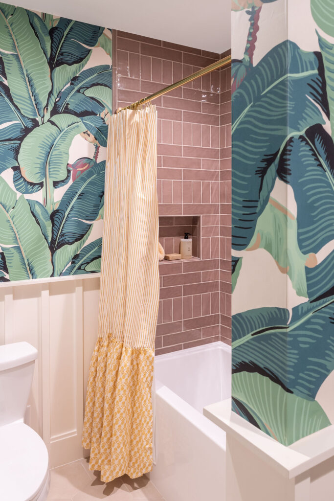 Interior Design Bathroom Remodel with brown mocha mousse shower tile and palm leaf wallpaper.