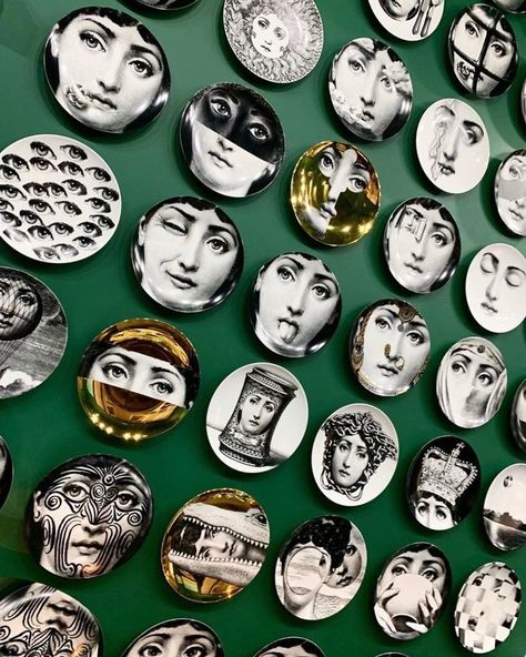 Fornasetti Face plates on green wall