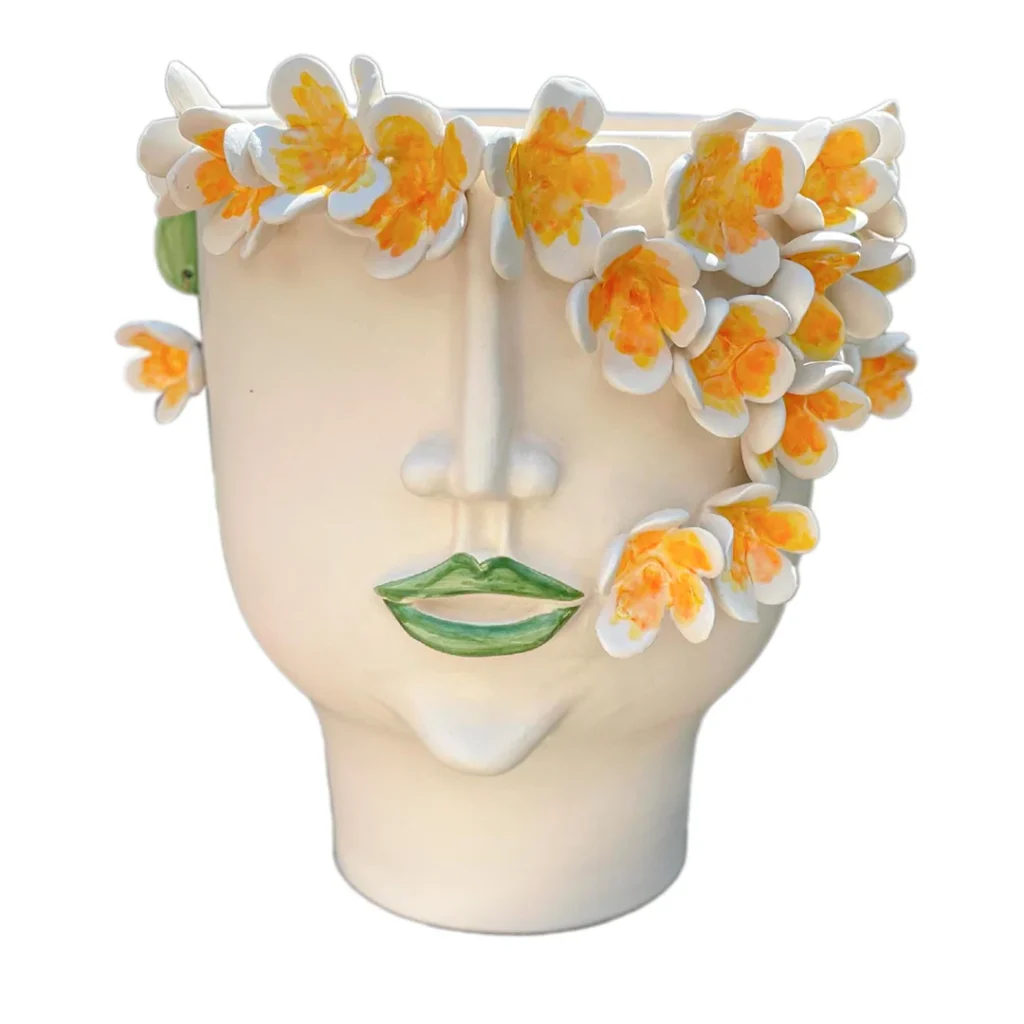 Patrizia Italiano
Frangipani Sculpture
Face pot with white and yellow flowers